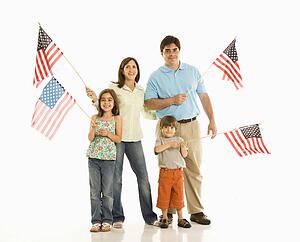 Hispanic family holding American flags.