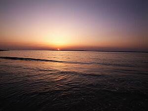 Sun setting over horizon of Atlantic ocean.