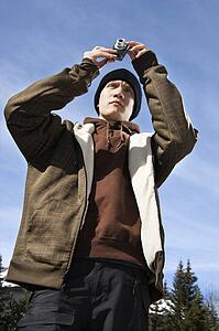 Teenager taking a picture with a digital camera