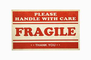 Fragile handle with care sign against white background.