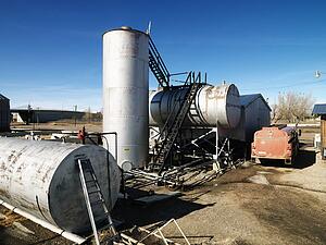 Rural landscape with metal tanks.