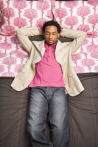 Male sleeping on bed