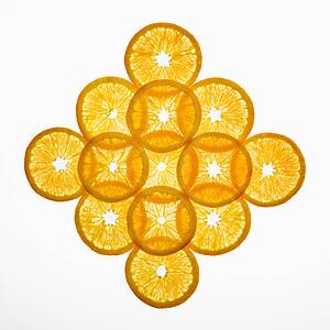 Orange slices arranged in design on white background.