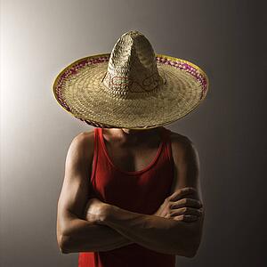 Portrait of a Mid-adult Caucasian male wearing sombrero holding maracas.