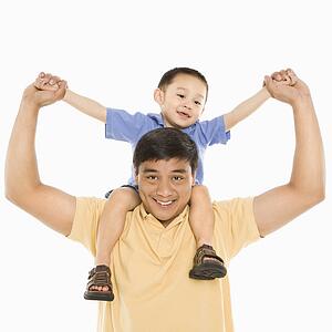 Father holding son on shoulders 