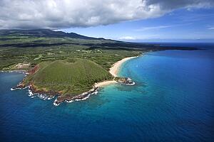 Aerial of Maui, Hawaii coastline with crater and cliffs and beach on Pacific ocean