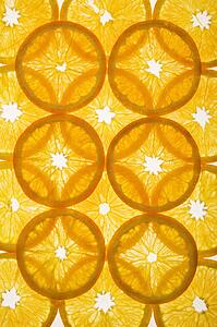 Orange slices arranged in design on white background.