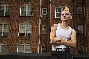 Male punk with building in background