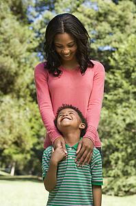 Mother and son looking at eachother smiling.
