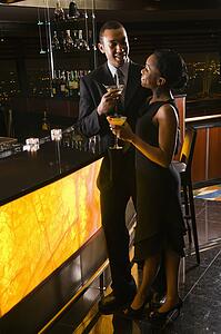 Young couple having drinks at the bar.