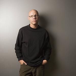 Portrait of mid-adult Caucasian male with hands in pockets.
