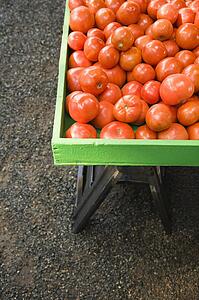 Pile of red tomatoes at produce market.