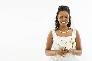 Bride holding bouquet on white background