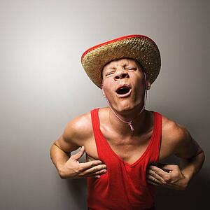 Male wearing hat and touching his chest