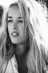 Black and white head and shoulder portrait of pretty blond Caucasian woman.
