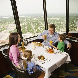 Family having dinner together at Tower of Americas restaurant in San Antonio, Texas