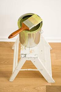 Paintbrush on can on top of step ladder
