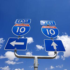 Highway interstate 10 sign with arrows pointing east and west