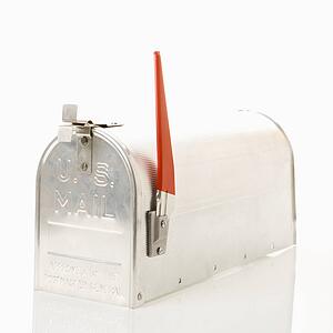 Silver metal mailbox with flag up