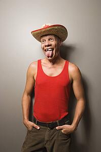 Male wearing straw hat sticking out tongue
