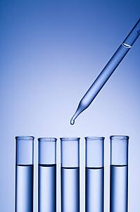 Dropper dropping liquid into test tube.