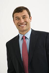 Portrait of smiling businessman against white background.