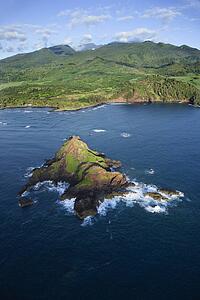 Pacific ocean off the coast of Maui, Hawaii with mountains 
