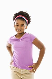 Girl with hands on hips smiling at viewer