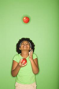 Girl juggling apples