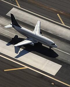 Aerial view of passenger airplane on airport runway