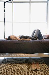 Woman lying on bed