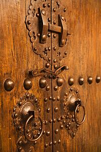 Wooden doors with ornate metal knobs and locks