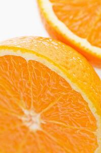 Close up of halved orange against white background.