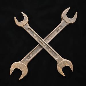 Two crossed crescent wrenches