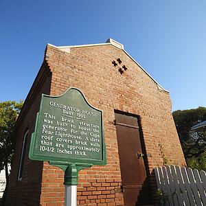 Low angle view of generator house for Cape Fear lighthouse at Bald Head Island, North Carolina.