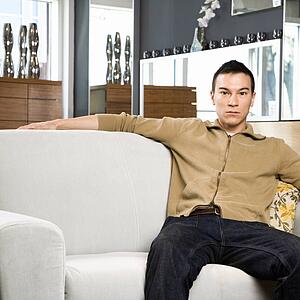 Portrait of a young man sitting on couch