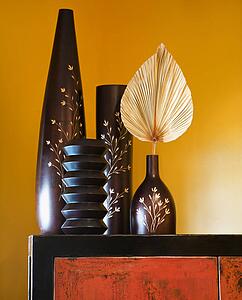 Still life of interior with Asian vases on dresser.