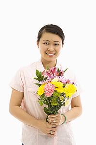 Mid adult woman holding bouquet of flowers