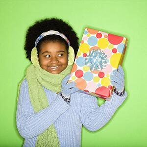 Girl in winter clothing holding wrapped package