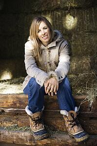 Woman sitting in barn 