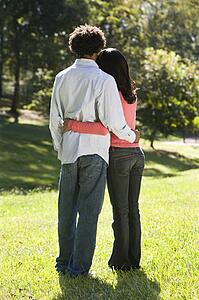 Couple standing in park 