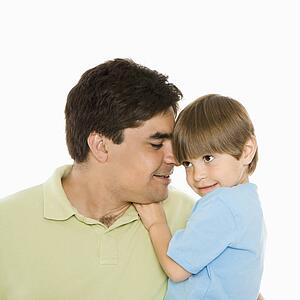 Close up portrait of father holding son against white background