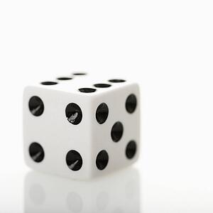 One white game die. 