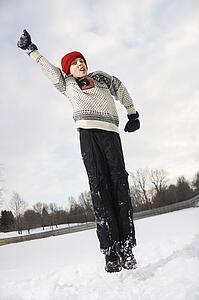 Boy wearing sweater and red winter cap 