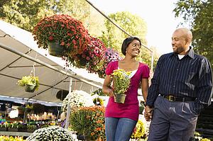 Happy smiling couple picking out flowers