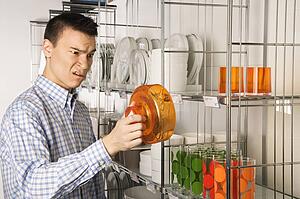 Young man shopping for dishes and glasses 