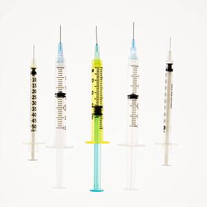 Several hypodermic needles on white background.