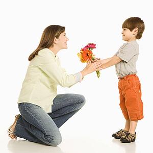 Son giving bouquet of flowers to mother