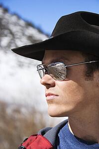 Mid-adult man wearing sunglasses and cowboy hat