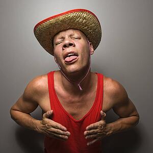 Portrait of a mid-adult Caucasian male wearing straw hat and touching his chest.